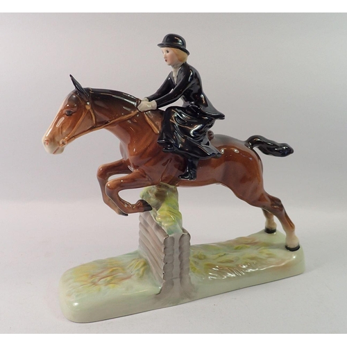 177 - A Beswick huntswoman riding side saddle, taking a fence