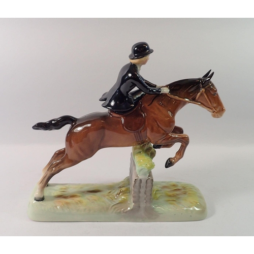 177 - A Beswick huntswoman riding side saddle, taking a fence