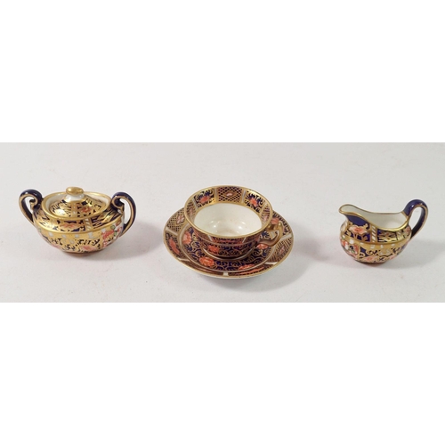 183 - A Royal Crown Derby miniature covered sugar bowl, jug and teacup, 3cm tall