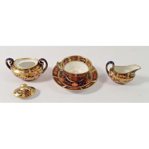 183 - A Royal Crown Derby miniature covered sugar bowl, jug and teacup, 3cm tall