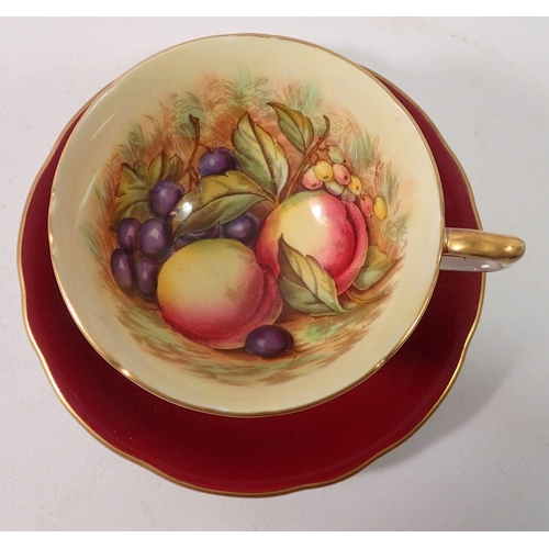 188 - An Anysley tea cup and saucer printed fruit, by James