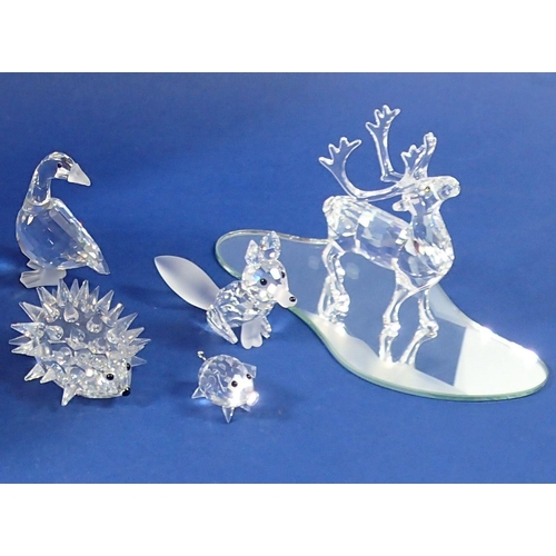 231 - A group of Swarovski glass animals: reindeer, pig, fox, goose and hedgehog - all boxed