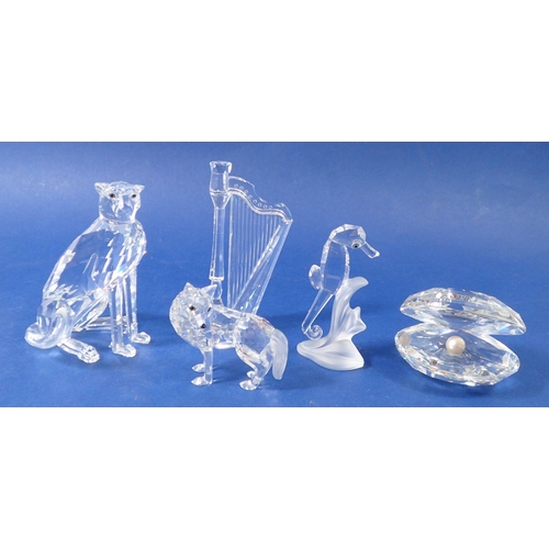 237 - A group of Swarovski glass animals: cheetah, oyster shell, Irish harp, seahorse and wolf - all boxed