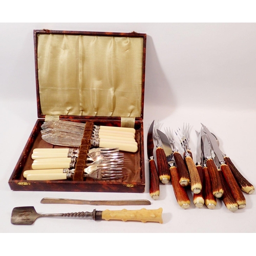 257 - A set of six silver collared fish knives and forks cased together with a silver collared marrow scoo... 