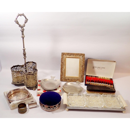 261 - A box of silver plated items including a three bottle decanter, pin cushion, Zimco tray etc.