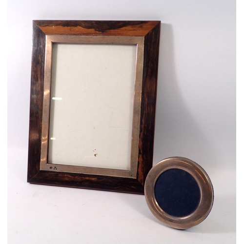 273 - A small silver circular picture frame with easel back together with a larger hanging hardwood frame ... 