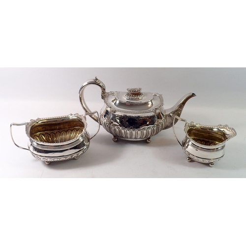 276 - An early 19th century matched silver tea set with scrollwork border and halfgadrooned base, London 1... 