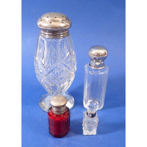 282 - A Victorian cranberry glass smelling salts bottle with silver plated mounts, two other smelling salt... 