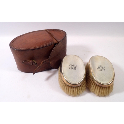 309 - A pair of silver backed gentlemen's brushes in leather case