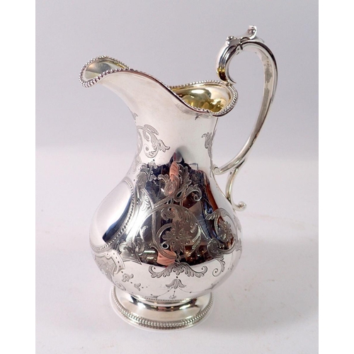 325 - A Victorian silver milk jug with engraved decoration, London 1860 by Barnards, 257g, 15cm tall