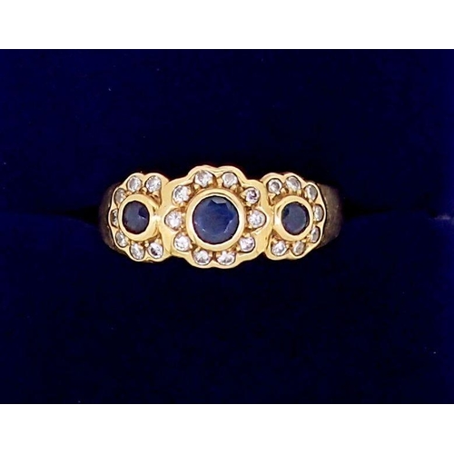 369 - An 18 carat gold ring set triple sapphire and diamond cluster, size N, 4.4g