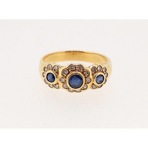 369 - An 18 carat gold ring set triple sapphire and diamond cluster, size N, 4.4g