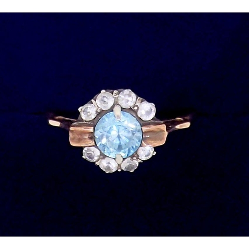 372 - An unmarked gold ring set blue topaz and diamond cluster, size M, tested as 9ct gold