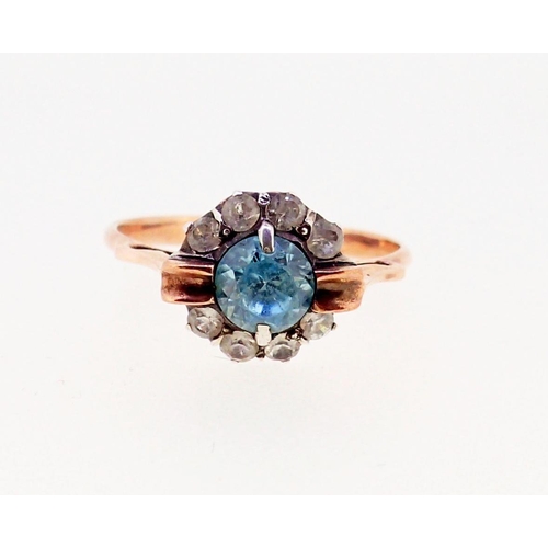 372 - An unmarked gold ring set blue topaz and diamond cluster, size M, tested as 9ct gold