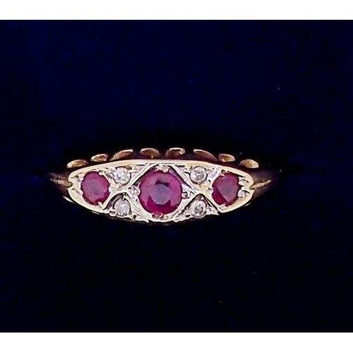 374 - A 9 carat gold ruby three stone ring inset diamonds, 2g, size N