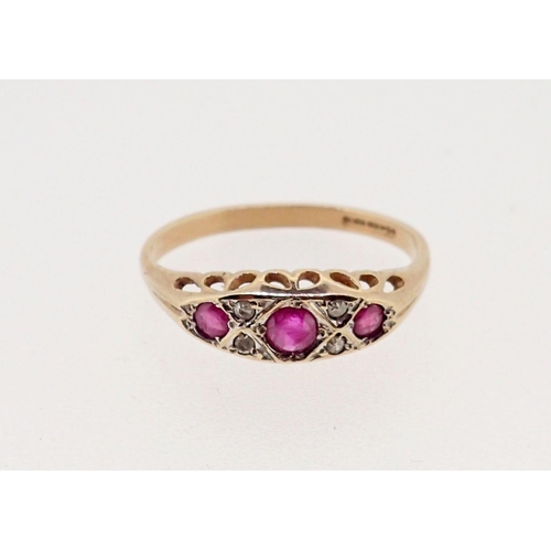 374 - A 9 carat gold ruby three stone ring inset diamonds, 2g, size N