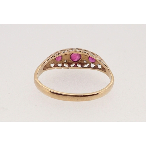 374 - A 9 carat gold ruby three stone ring inset diamonds, 2g, size N