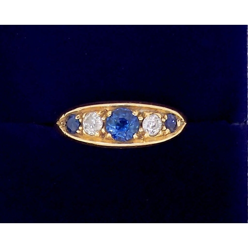 376 - An 18 carat gold ring set three sapphires and two diamonds, marks worn, 2.3 x 1.2cm, size N, 4.6g