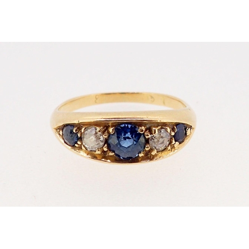 376 - An 18 carat gold ring set three sapphires and two diamonds, marks worn, 2.3 x 1.2cm, size N, 4.6g