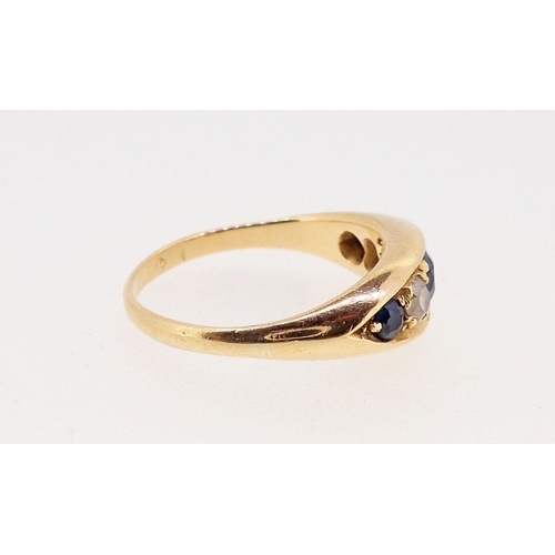 376 - An 18 carat gold ring set three sapphires and two diamonds, marks worn, 2.3 x 1.2cm, size N, 4.6g