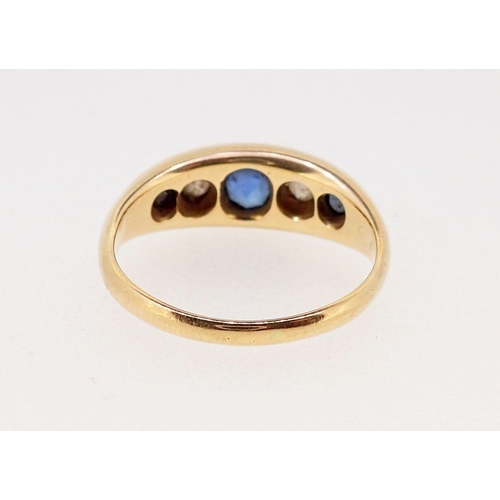 376 - An 18 carat gold ring set three sapphires and two diamonds, marks worn, 2.3 x 1.2cm, size N, 4.6g