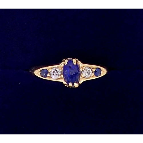 379 - An 18 carat gold ring set three sapphires and two diamonds, size M, sapphire chipped, 3g