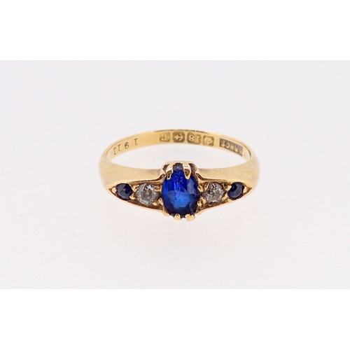 379 - An 18 carat gold ring set three sapphires and two diamonds, size M, sapphire chipped, 3g