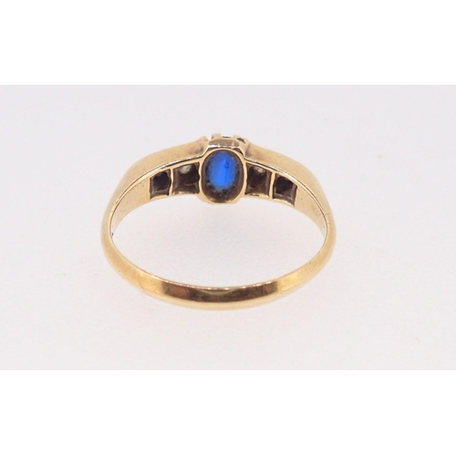 379 - An 18 carat gold ring set three sapphires and two diamonds, size M, sapphire chipped, 3g