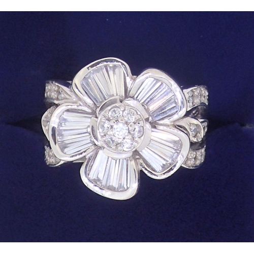 385 - An 18 ct white gold floral cluster ring set white stones, 11g, size P