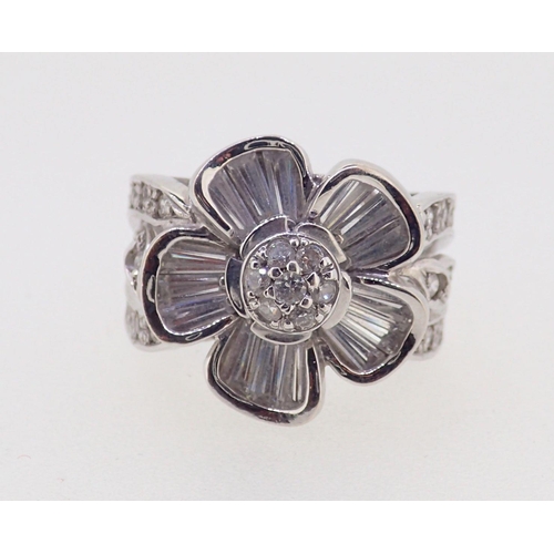 385 - An 18 ct white gold floral cluster ring set white stones, 11g, size P