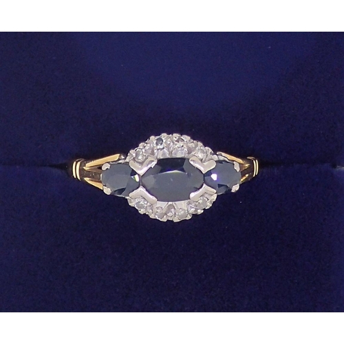 386 - An 18 carat gold ring set three marquise cut sapphires and chip diamonds, size M