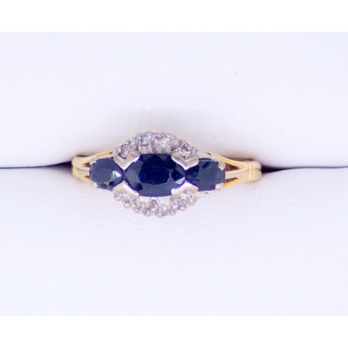 386 - An 18 carat gold ring set three marquise cut sapphires and chip diamonds, size M