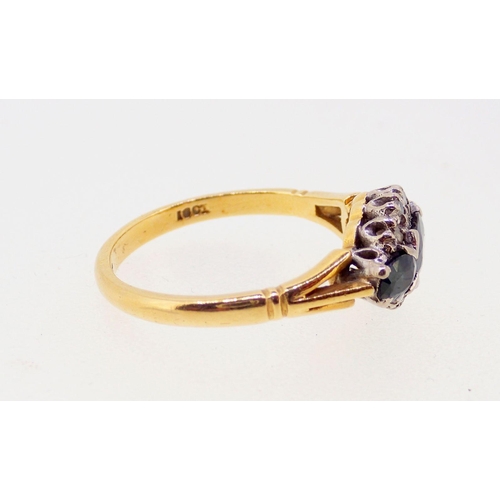 386 - An 18 carat gold ring set three marquise cut sapphires and chip diamonds, size M