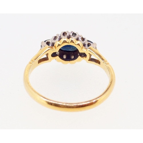 386 - An 18 carat gold ring set three marquise cut sapphires and chip diamonds, size M