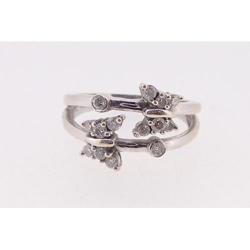 387 - An 18ct white gold split shank ring with two diamond set butterflies, 4.9g, size N to O