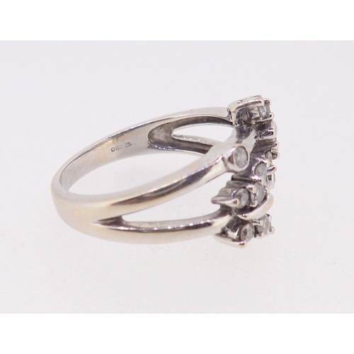 387 - An 18ct white gold split shank ring with two diamond set butterflies, 4.9g, size N to O