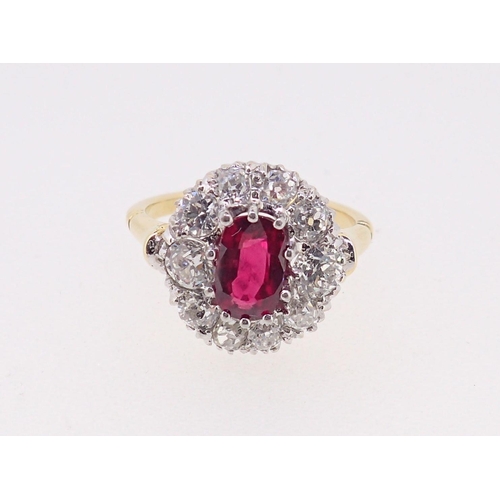 388 - A fine 18ct gold ruby and diamond oval cluster ring, the ruby 7mm x 4mm approx., size M, 4.8g