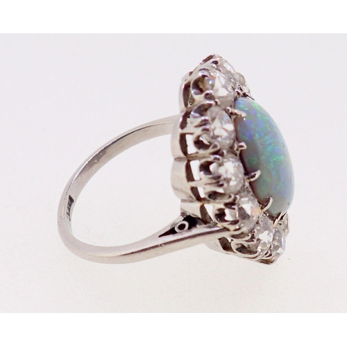 389 - A large platinum opal and diamond cluster ring, the opal 12mm x 9mm, the twelve brilliant cut diamon... 