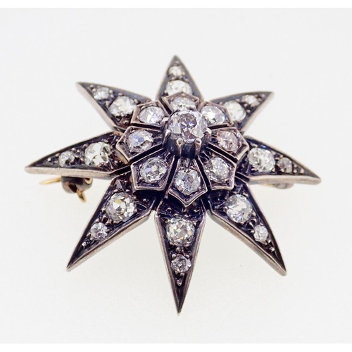 390 - A diamond set star form brooch 3.7cm diameter, 10g, unmarked but thought to be 18ct gold