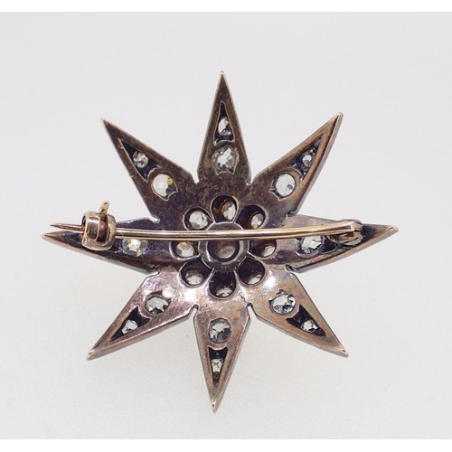 390 - A diamond set star form brooch 3.7cm diameter, 10g, unmarked but thought to be 18ct gold