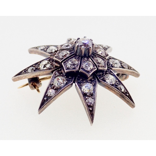 390 - A diamond set star form brooch 3.7cm diameter, 10g, unmarked but thought to be 18ct gold