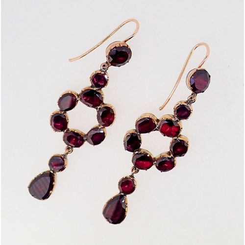 393A - A pair of antique garnet set gold pendant earrings of circle and drop form, 5cm long,