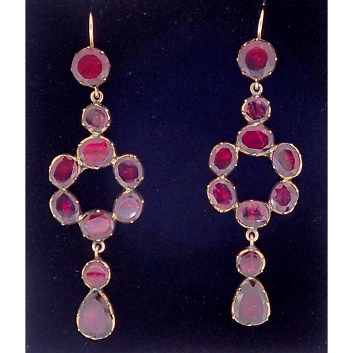 393A - A pair of antique garnet set gold pendant earrings of circle and drop form, 5cm long,