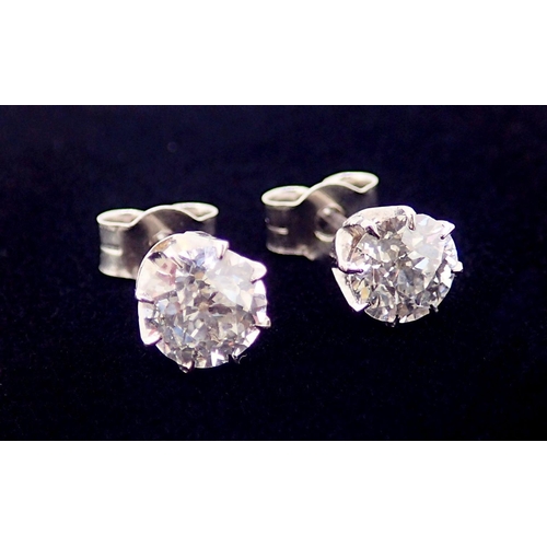 393B - A pair of white gold set diamond stud earrings, just under one carat in total