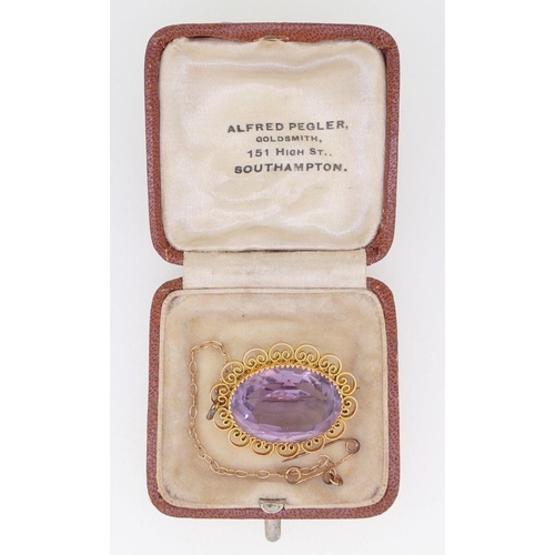 394 - A 9 carat gold oval filigree mounted amethyst brooch, 2.5cm, boxed