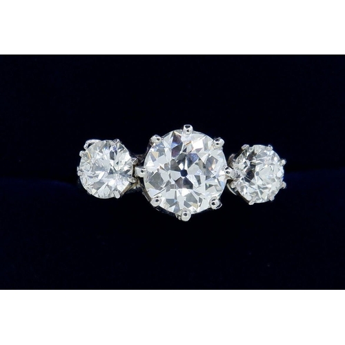 403 - A fine quality platinum set three stone diamond ring, 2.5 cts in total, size M