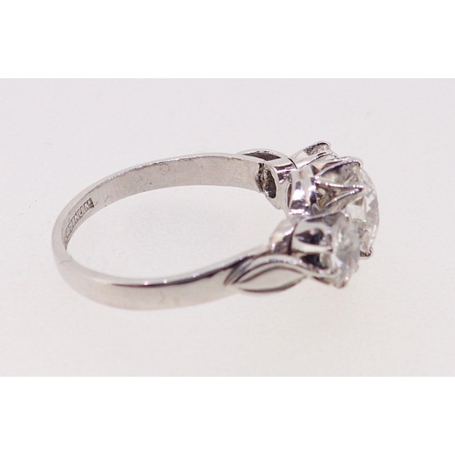 403 - A fine quality platinum set three stone diamond ring, 2.5 cts in total, size M