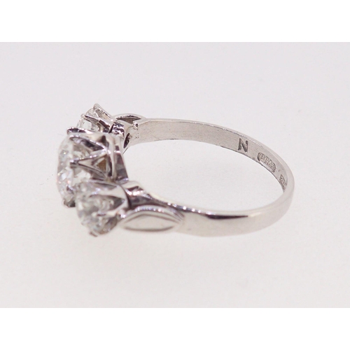 403 - A fine quality platinum set three stone diamond ring, 2.5 cts in total, size M