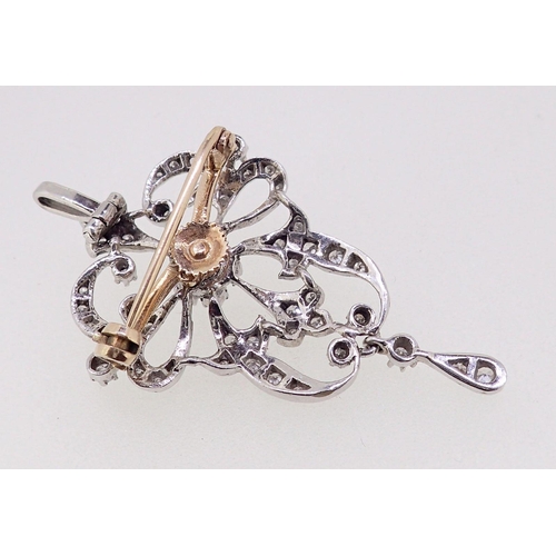 412 - A white metal diamond set openwork pendant/brooch in Bell Epoque style, 4.5cm