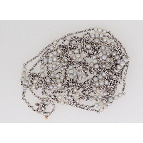 423 - An Edwardian long white metal necklace set seed pearls, 148cm long, 17.5g